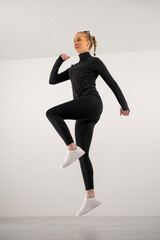 Fitness enthusiast jumping in activewear