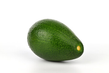 A green avocado sits on a white background