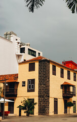 Urban yellow house with brown trim.