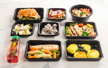 Healthy meal delivery with assorted dishes in plastic containers