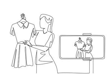 Continuous one line drawing woman holds clothes on a hanger and doing live streaming using a smartphone. Online business. Review. National Streaming Day. Single line draw design vector illustration