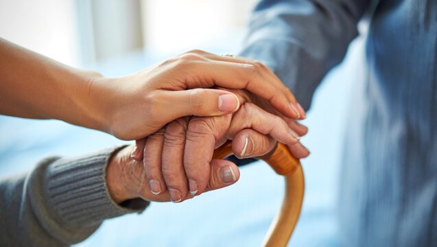 Compassionate Touch Supporting Senior with Cane, Offering Help