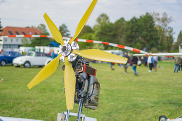 Close-up of four bladed yellow propeller and exposed aircraft engine