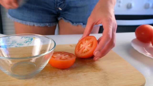 Woman chef hands cutting and deseeding tomatoes in bowl on kitchen at home. Culinary skills techniques, homemade prepare healthy meal, cook domestic food vegetable, cuisine, fresh ingredient.