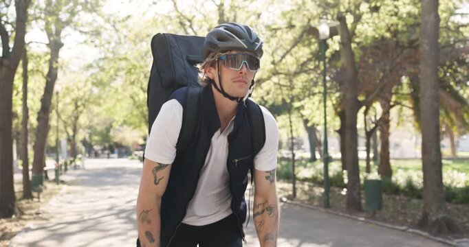 Man, delivery and checking watch with bicycle in park for deadline order or schedule package. Male person, time and wristwatch with backpack on bike for rush, commute or courier service in nature