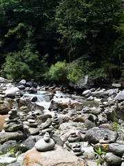 Stone stacks by the Passiria river in South Tyrol, Italy – symbol of balance and mindfulness in nature