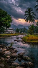 Obraz premium Scenic river flows through village under a dramatic, stormy sky, with palms