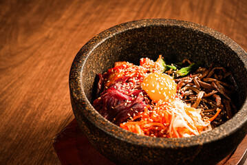 Korean stone pot bibimbap with egg yolk and vegetables
