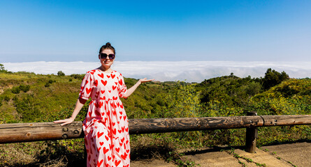 Panoramic portrait of a mature girl in sunglasses in the mountains.