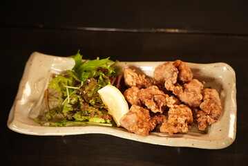 Japanese fried chicken karaage with salad and lemon