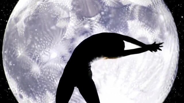 Dancer's graceful form against lunar backdrop under the night sky creates silhouette