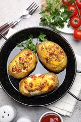 Tasty stuffed baked potatoes served on grey table, flat lay