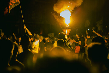 Yellow flare burning during student's protest against the government in Serbia.