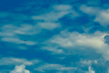 Cloudy summer sky view with two biplanes near Moos, Deggendorf, Bavaria, Germany