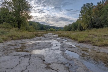 Fototapeta premium Tranquil landscape of a dried riverbed at dawn.