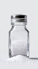 Clear glass salt shaker with white crystals
