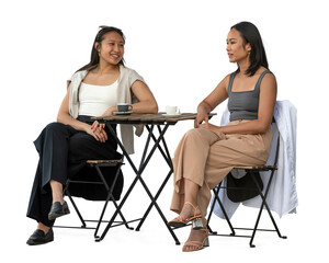 Two young Vietnamese women sitting in a cafeteria and talking, isolated on white and transparent...