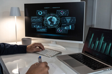 Professional analyzing global marketing data on a large monitor while taking notes, optimizing digital campaigns