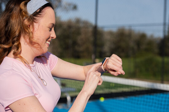 woman checking the data on her fitness tracker smartwatch