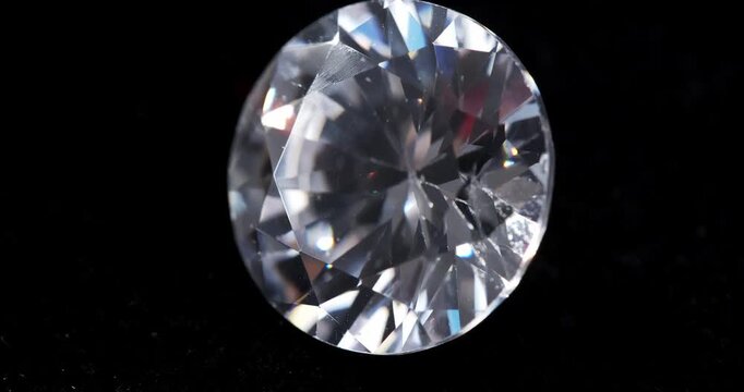 Jewelry zirconia stone on a dark background. Artificial gemstone on a rotating table.