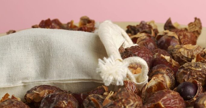 Soap nuts and eco laundry bag, close-up footage on a rotating table.