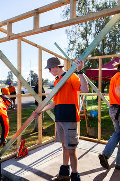 Trade apprentices during hands on learning course attaching temporary support to frame