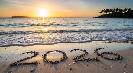 The year 2026 written in sand on a beach at sunset