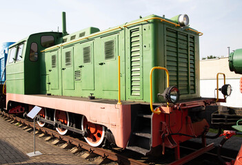 Vintage green locomotive on display at a railway museum showcasing historical transportation technology
