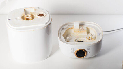 Dirty humidifier from hard water and mold. Hard water and scale, rust in white humidifier, close-up