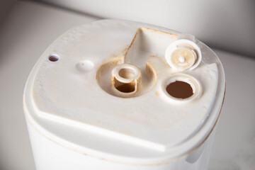 Unpleasant smell, rust and scale from water in the humidifier, white background, close-up