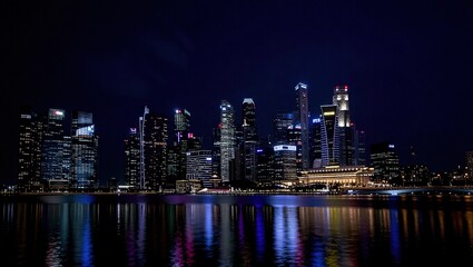 Obraz premium Singapore City Skyline at Night with Marina Bay Sands and Financial District Reflected in Water.
