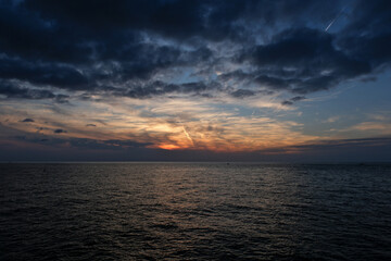 Cloudscape, Colored Clouds at Sunset near the Sea. Sunset over the sea in the evening. Sea and sky
