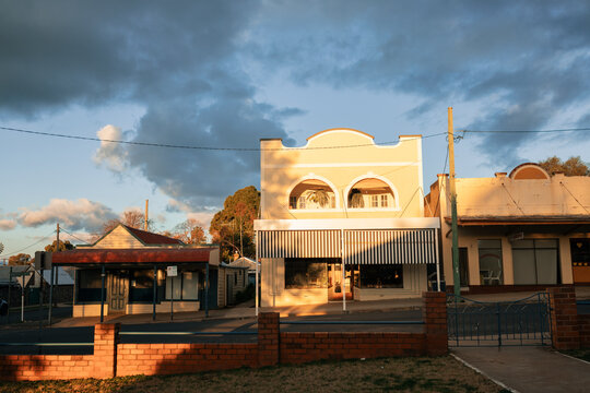 View over low brick fence of historic buildings along quiet street in Australia