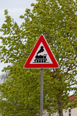 European Triangular Warning Sign Railway Crossing without Barrier with Trees Background