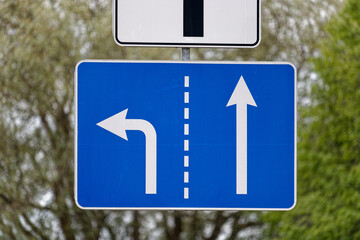 European Blue Rectangular Road Sign Indicating Left Lane Turn Left and Right Lane Ahead