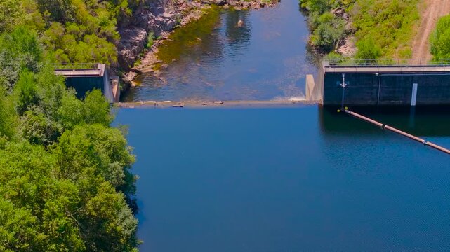 Dense Tropical Forest In River Lerez Reservoir And Dam In Galicia, Spain. Aerial Pullback Shot