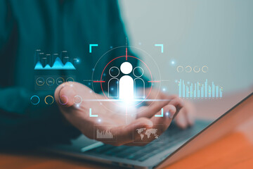 Businessman using laptop with digital customer data analysis target audience interface, concept of marketing strategy, business analytics, customer relationship management, digital transformation.