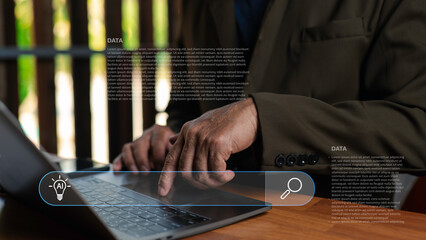 Businessman using laptop with artificial intelligence and big data search interface. Concept of digital technology, machine learning, data analysis, and innovation in modern business.