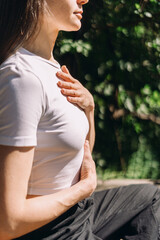 Woman practices yoga outdoors, focusing on deep breathing and mindfulness