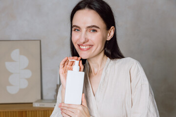 Young woman enjoying skincare routine with beauty products at home
