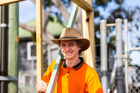 portrait of smiling young bloke working on jobsite during hands on apprenticeship trade course