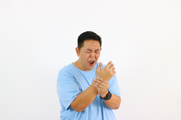 Man Gripping Wrist in very bad Pain