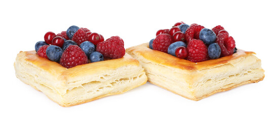 Yummy puff pastries with berries isolated on white
