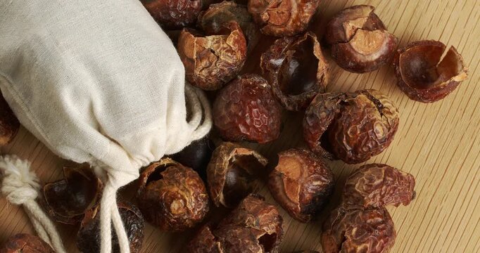 Soap nuts and eco laundry bag, close-up footage on a rotating table.