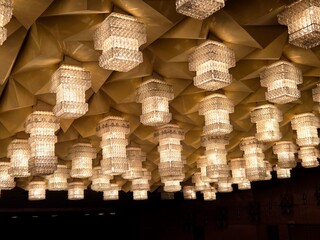 Modern pendant lights. Identical lights on the ceiling of the theater. beautiful ceiling lamp with light bulb, beautiful ceiling decoration with chandelier