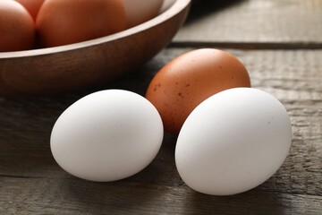 Fresh chicken eggs on wooden table, closeup