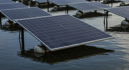 A floating solar farm consists of multiple panel arrays on pontoons to generate electricity on a water surface. Concept of large-scale floatovoltaic power generation.