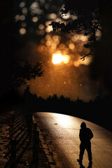 Autumn walk of a silhouette of a person walking towards his dreams.