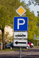 European Small Main Road Sign with Parking Area for Cars Indicated to the Left