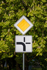 European Priority Road Sign Indicating Main Road to the Left with Side Roads Straight and Right